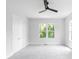 A bedroom with carpet, ceiling fan, neutral walls and windows looking outside at 1610 Niskey Lake Rd, Atlanta, GA 30331