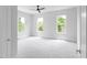 A bright bedroom with carpet, ceiling fan, neutral walls and many windows looking outside at 1610 Niskey Lake Rd, Atlanta, GA 30331