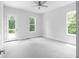 Bright bedroom with neutral walls and carpet, with ceiling fan and access to a private deck at 1610 Niskey Lake Rd, Atlanta, GA 30331