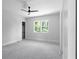 A bright bedroom with gray carpet, a ceiling fan and an outside view from the windows at 1610 Niskey Lake Rd, Atlanta, GA 30331
