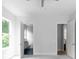 Neutral bedroom featuring doorways to two adjacent rooms and a bright window at 1610 Niskey Lake Rd, Atlanta, GA 30331