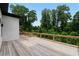 Large wooden deck with black metal railings, surrounded by dense trees and greenery at 1610 Niskey Lake Rd, Atlanta, GA 30331
