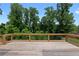 Spacious wooden deck overlooks a lush backyard surrounded by mature trees offering a serene outdoor space at 1610 Niskey Lake Rd, Atlanta, GA 30331