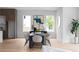 Modern dining area features large windows, a sleek black table, and minimalist decor for sophisticated dining at 1610 Niskey Lake Rd, Atlanta, GA 30331