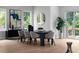 Contemporary dining room with abundant natural light, a stylish table set, and views of the green outdoors at 1610 Niskey Lake Rd, Atlanta, GA 30331