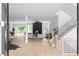 Bright foyer with hardwood floors, modern staircase, and an open-concept view into the living room and dining area at 1610 Niskey Lake Rd, Atlanta, GA 30331