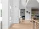 Bright and airy foyer with hardwood floors, showcasing a built-in seating area and an open view to the kitchen at 1610 Niskey Lake Rd, Atlanta, GA 30331