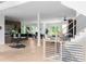 Open-concept layout with hardwood floors leading to a modern kitchen, dining area, and living room, filled with natural light at 1610 Niskey Lake Rd, Atlanta, GA 30331