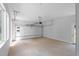 Spacious two-car garage with white walls, concrete floor, windows, and a roll-up door at 1610 Niskey Lake Rd, Atlanta, GA 30331