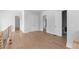 Upstairs hallway with hardwood floors, white walls and trim, and modern railing at 1610 Niskey Lake Rd, Atlanta, GA 30331