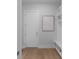 Hallway featuring a front door, modern decor, built-in shelving, and light wood floors at 1610 Niskey Lake Rd, Atlanta, GA 30331