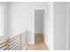 Hallway with light hardwood floors and modern railing on the stairway to the second floor at 1610 Niskey Lake Rd, Atlanta, GA 30331