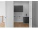 A laundry room featuring modern gray cabinets, a white washer-dryer and light wood floor at 1610 Niskey Lake Rd, Atlanta, GA 30331