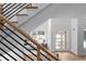 View of the light and airy living room from the staircase showing the front entrance and large windows at 1610 Niskey Lake Rd, Atlanta, GA 30331