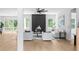 Open living room with modern black fireplace and light-filled windows at 1610 Niskey Lake Rd, Atlanta, GA 30331