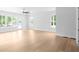 Bright, open-concept living room with natural light, light hardwood floors and white walls at 1610 Niskey Lake Rd, Atlanta, GA 30331