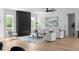 Contemporary living room features a striking black fireplace, large windows, and neutral decor for a serene space at 1610 Niskey Lake Rd, Atlanta, GA 30331