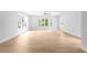 Bright, open-concept living room with natural light, light hardwood floors and white walls at 1610 Niskey Lake Rd, Atlanta, GA 30331