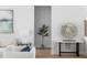 Bright, minimalist living room with neutral decor, modern art, and a decorative accent table at 1610 Niskey Lake Rd, Atlanta, GA 30331