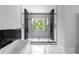 Modern bathroom with a luxurious glass shower and sleek marble and black tiled accents at 1610 Niskey Lake Rd, Atlanta, GA 30331