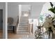 Bright foyer showcasing a modern staircase with wooden treads, light wood handrails, and black iron balusters at 1610 Niskey Lake Rd, Atlanta, GA 30331
