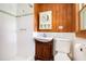 A bathroom with tiled walls, wood accents, and a shower at 2595 Woodhill Cir, Atlanta, GA 30344