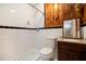Classic bathroom featuring black and white tile and wood cabinets, adding warmth and style at 2595 Woodhill Cir, Atlanta, GA 30344