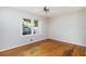 Empty room with hardwood floors, a ceiling fan, and a large window at 2595 Woodhill Cir, Atlanta, GA 30344