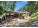 Brick home with a carport, mature trees, and ample parking space creating curb appeal at 2595 Woodhill Cir, Atlanta, GA 30344