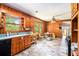 Bright eat-in kitchen featuring wood cabinetry, tile flooring, and natural light at 2595 Woodhill Cir, Atlanta, GA 30344