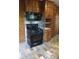 A kitchen featuring wood paneling and black appliances at 2595 Woodhill Cir, Atlanta, GA 30344