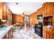 Cozy kitchen with wood paneling, colorful floor tiles, and an adjacent dining area at 2595 Woodhill Cir, Atlanta, GA 30344