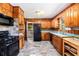Cozy kitchen featuring wood cabinetry, tile backsplash, and plentiful storage at 2595 Woodhill Cir, Atlanta, GA 30344