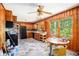 Bright kitchen with wood paneling, a dining area, and large windows with views at 2595 Woodhill Cir, Atlanta, GA 30344
