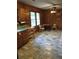 Eat-in kitchen featuring wood cabinetry, neutral countertops, and tile flooring at 2595 Woodhill Cir, Atlanta, GA 30344