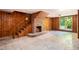Inviting living room with wood paneling, a cozy brick fireplace, and ample space at 2595 Woodhill Cir, Atlanta, GA 30344