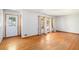 Bright living room with gleaming hardwood floors, large windows, and decorative front door at 2595 Woodhill Cir, Atlanta, GA 30344