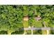Aerial view of a charming home nestled amongst lush trees and greenery on a spacious lot at 5689 Woodland Dr, Acworth, GA 30102