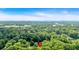 Panoramic aerial view showcasing the home nestled amongst lush greenery and surrounding landscape at 5689 Woodland Dr, Acworth, GA 30102