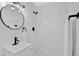 Modern bathroom with black fixtures, tile, and a stylish round mirror at 5689 Woodland Dr, Acworth, GA 30102