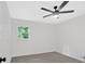 Clean, modern bedroom with a ceiling fan and a window providing natural light at 5689 Woodland Dr, Acworth, GA 30102