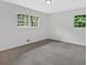 Bright bedroom featuring neutral walls, plush carpeting, and a sun-filled windows offering an inviting space at 5689 Woodland Dr, Acworth, GA 30102