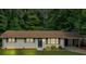 Charming brick home with dark shutters and front yard landscaping at 5689 Woodland Dr, Acworth, GA 30102