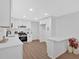 Modern kitchen with white cabinets, stainless appliances, breakfast bar and wood look floors at 5689 Woodland Dr, Acworth, GA 30102