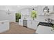 Bright kitchen with stainless appliances, white cabinets, and adjoining dining area with sliding glass doors at 5689 Woodland Dr, Acworth, GA 30102