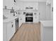 Bright kitchen featuring white cabinets, stainless steel appliances, and ample counter space at 5689 Woodland Dr, Acworth, GA 30102