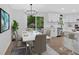 Eat-in kitchen with modern white cabinets, stainless steel appliances, dining area, and a sliding glass door at 5689 Woodland Dr, Acworth, GA 30102