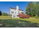 Backyard with a multi-level deck, a large grassy area, and mature trees at 6645 Crest Wood Ln, Douglasville, GA 30135