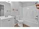 Well-maintained bathroom with a shower-tub combo, white toilet and vanity, and tile flooring at 6645 Crest Wood Ln, Douglasville, GA 30135