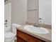 Inviting powder room featuring a wood vanity, white toilet, and neutral walls at 6645 Crest Wood Ln, Douglasville, GA 30135